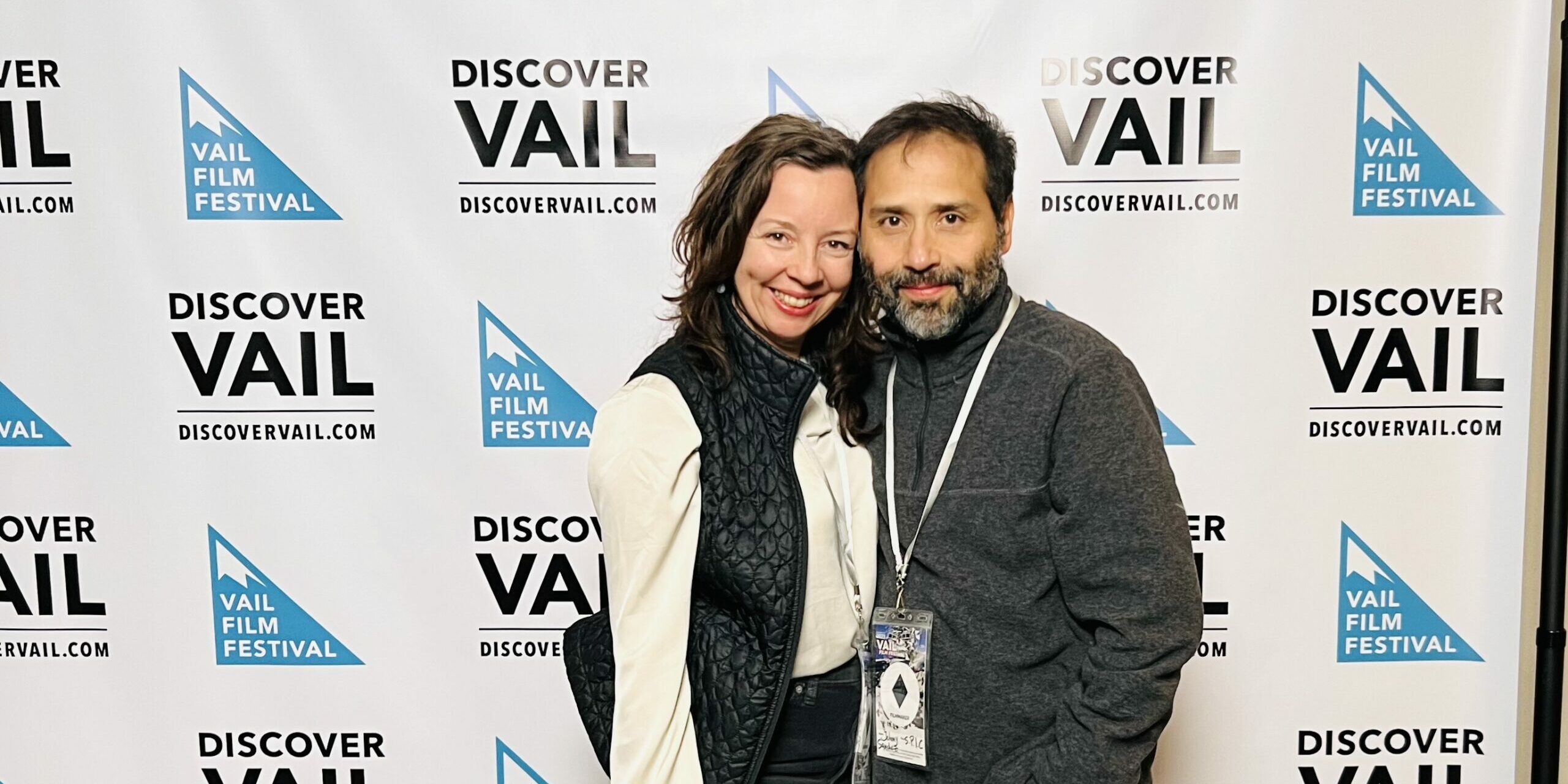 Heidi Marshall and Johnny Sanchez posing in front of step-and-repeat at Vail Film Festival for premiere of S.P.I.C. short film