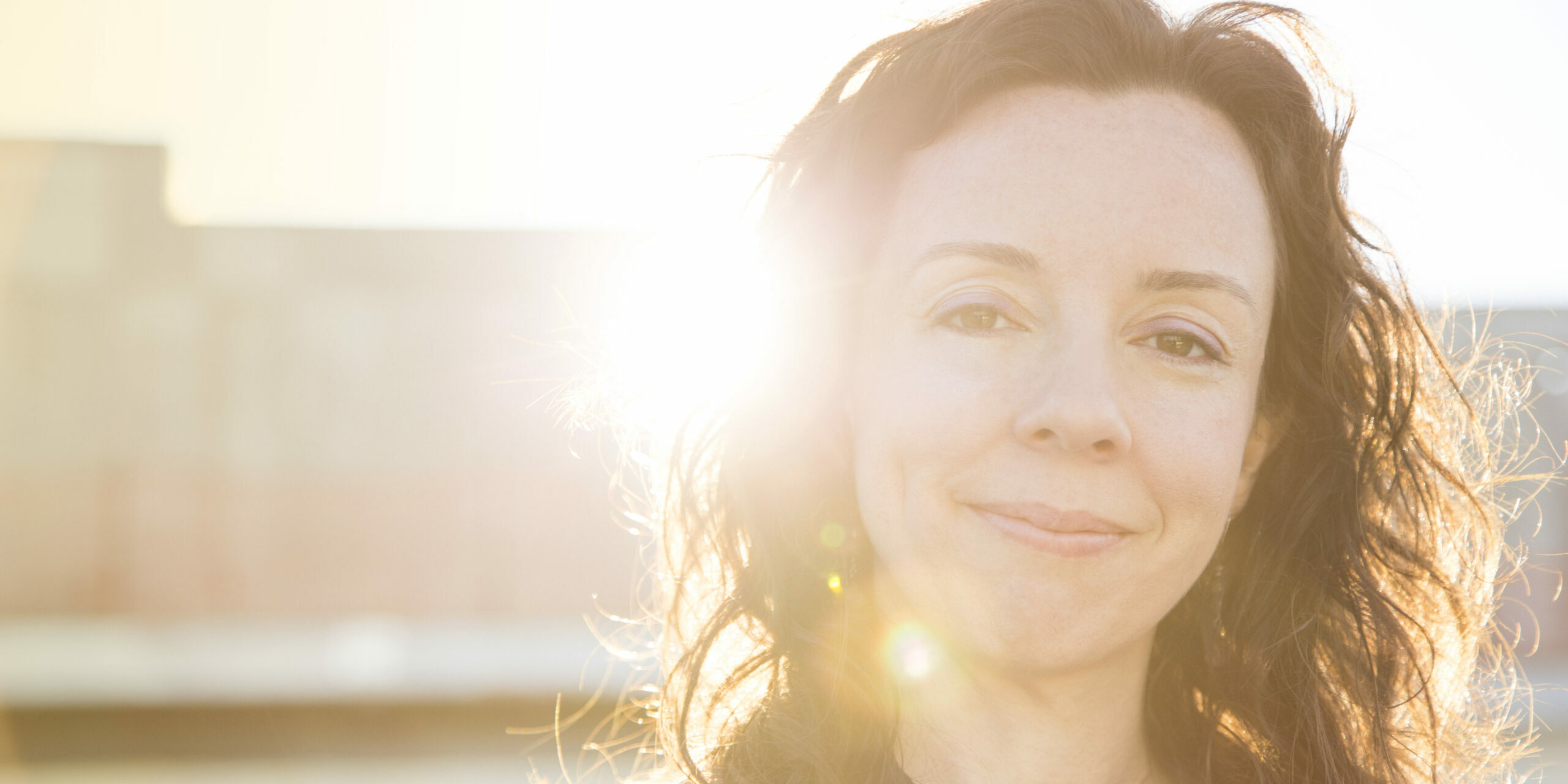 NYC On-Camera Class Acting Coach Heidi Marshall on rooftop backlit by sun